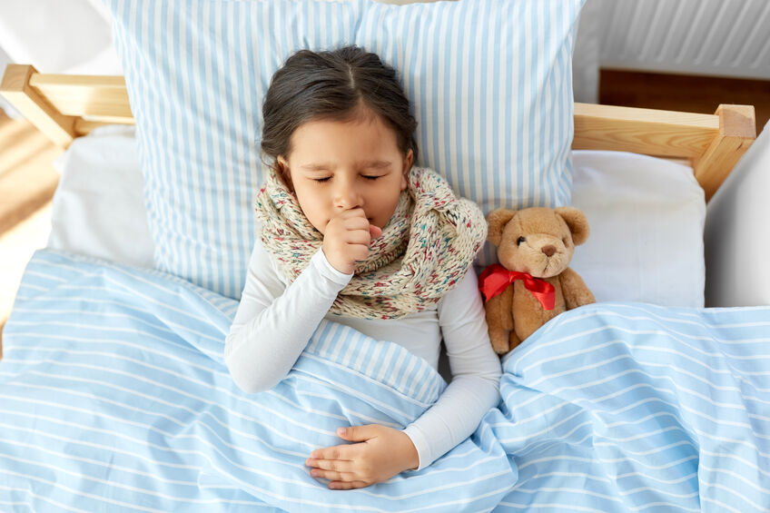 young girl sick in bed with cold